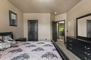 Bedroom featuring a textured ceiling and carpet floors