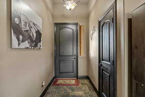 Entryway featuring baseboards and stone finish floor