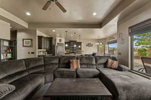 Living room featuring recessed lighting, ceiling fan, and a textured ceiling