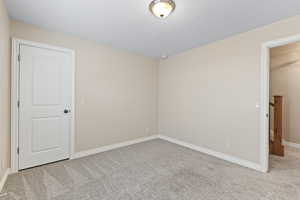 Empty room with baseboards and carpet floors