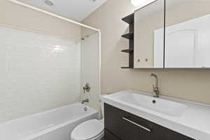Full bathroom with vanity,  shower combination, and toilet