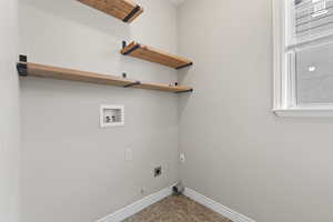 Clothes washing area featuring baseboards, electric dryer hookup, gas dryer hookup, laundry area, and hookup for a washing machine