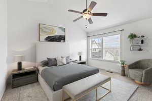 Bedroom with baseboards, a ceiling fan, visible vents, lofted ceiling, and carpet
