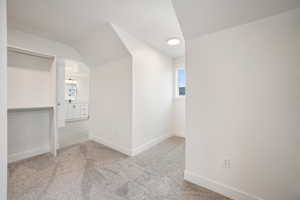 Carpeted spare room with baseboards