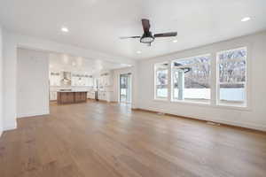 Unfurnished living room featuring visible vents, baseboards, a ceiling fan, recessed lighting, and light wood-style flooring