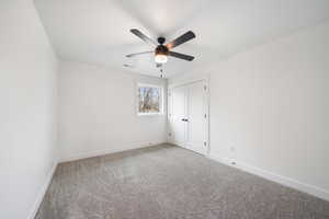 Unfurnished room with baseboards, carpet flooring, ceiling fan, and visible vents