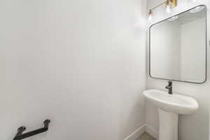 Bathroom with a sink and baseboards