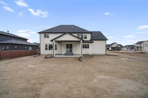 Rear view of property featuring entry steps, fence, a shingled roof, and stucco siding