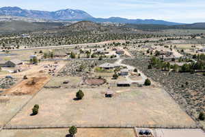 Drone / aerial view featuring view of desert, a mountain view, and a rural view