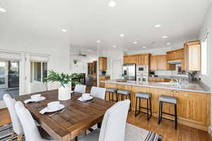 Dining space with light wood-type flooring, a ceiling fan, visible vents, and recessed lighting