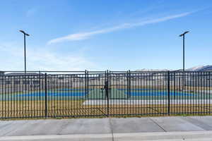 View of property's community with a mountain view and fence