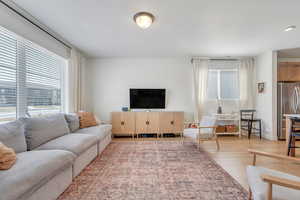 Living room featuring baseboards and light wood-type flooring