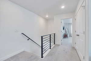 Stairs featuring carpet flooring, baseboards, and recessed lighting