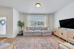 Living room with light wood-style flooring and baseboards