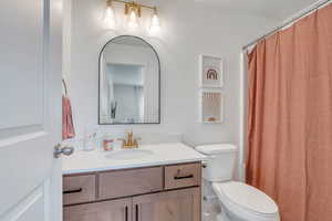 Full bath featuring vanity and toilet