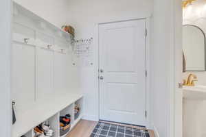 Mudroom with light wood finished floors