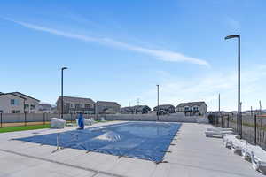 Pool featuring a residential view and a fenced backyard