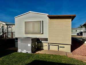 View of home's exterior with cooling unit