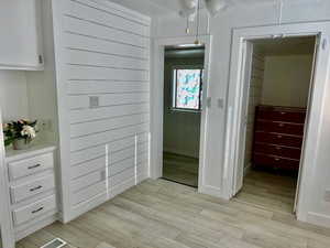 Hallway with visible vents and light wood finished floors
