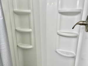Room details featuring a stall shower
