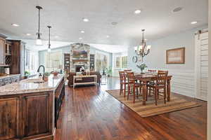 Dining area with recessed lighting,  chandelier,  fireplace, and wood floors