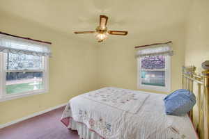 Bedroom with baseboards, carpet flooring, and ceiling fan