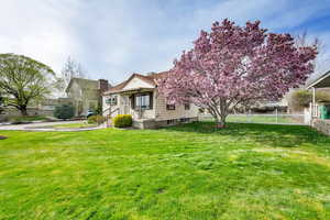 View of front of house featuring a front lawn, fence, and a chimney