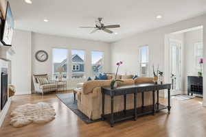 Living room featuring wood finished floors, ceiling fan, baseboards, and recessed lighting