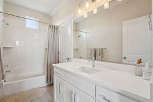Full bath featuring shower / tub combo, vanity, and tile patterned flooring
