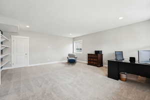 Carpeted home office with baseboards and recessed lighting