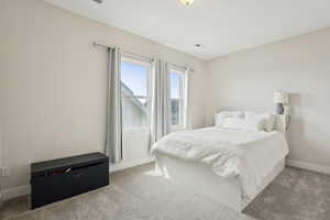 Bedroom with carpet floors and baseboards