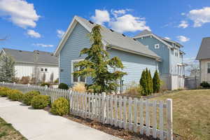 View of side of property with a lawn and a fenced front yard