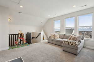 Interior space featuring visible vents, recessed lighting, carpet flooring, and lofted ceiling