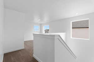 Hall featuring recessed lighting, baseboards, carpet floors, and an upstairs landing