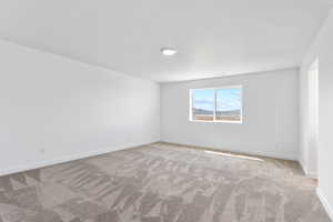 Carpeted empty room with baseboards