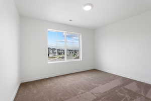 Empty room with visible vents, baseboards, and carpet flooring
