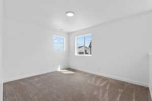 Empty room with carpet and baseboards
