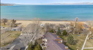 Birds eye view of property with a view of the beach and a water and mountain view