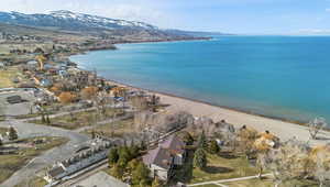 Birds eye view of property featuring a water and mountain view