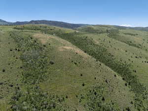 Aerial overview of property's location featuring a mountain backdrop