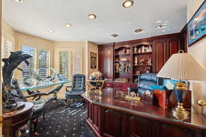 Carpeted office space featuring recessed lighting and a textured ceiling