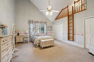 Bedroom with baseboards, high vaulted ceiling, light carpet, and a ceiling fan