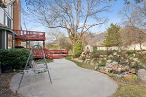 View of patio / terrace with a deck with mountain view