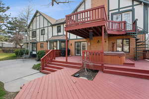 Deck featuring a patio area, a grill, and a hot tub
