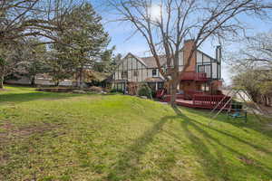 View of yard with a playground and a deck