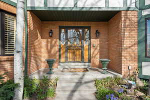 Property entrance with brick siding and covered porch