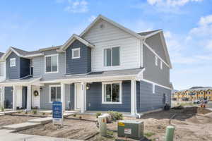 View of front of house featuring a shingled roof
