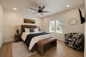 Bedroom featuring baseboards, recessed lighting, light wood-style floors, and a ceiling fan