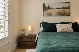 Bedroom featuring baseboards and wood finished floors