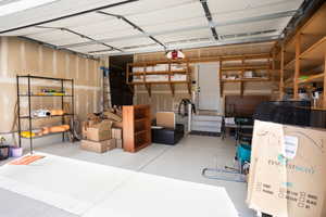 Garage with attached storage shelving.